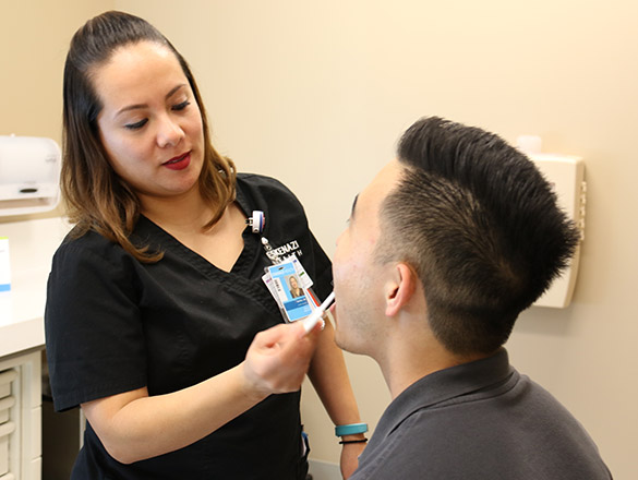 A provider obtains a saliva sample from a patient