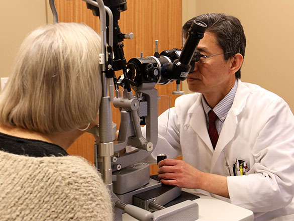 Doctor looking at patient's eyes through special machine