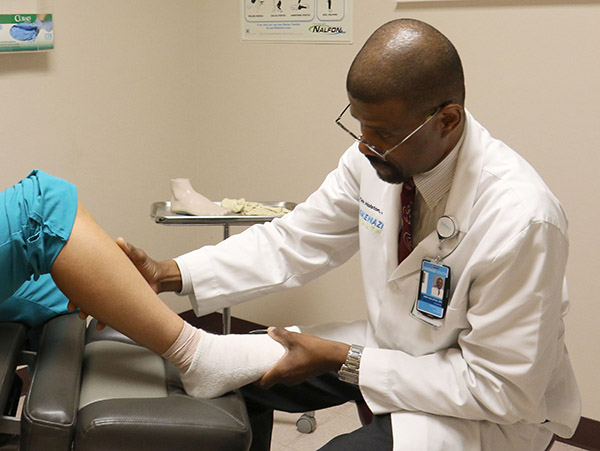 An Eskenazi Health provider examines a patients foot
