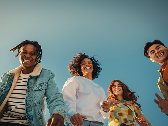 A group of four smiling teenagers