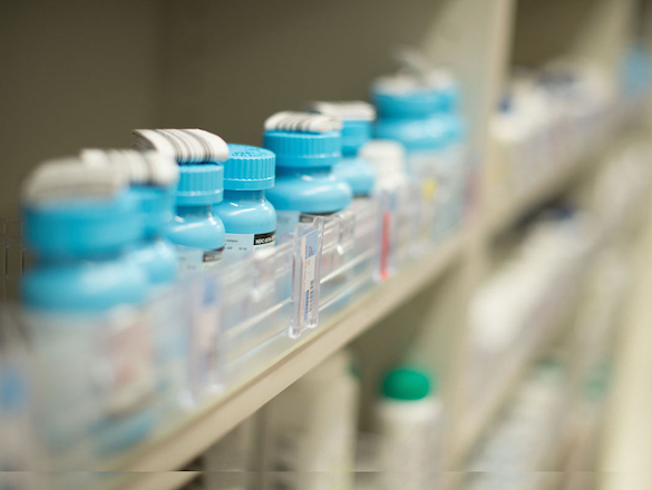 Rows of prescription bottles sit on a shelf
