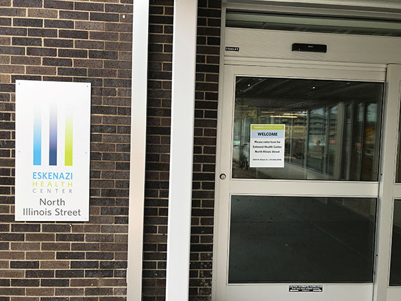 North Illinois Street facility entrance showing an Eskenazi Health plaque and a welcome sign